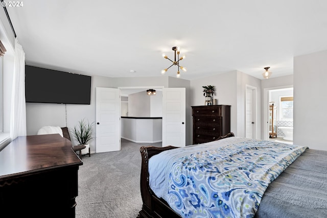 bedroom featuring a chandelier, connected bathroom, and carpet floors