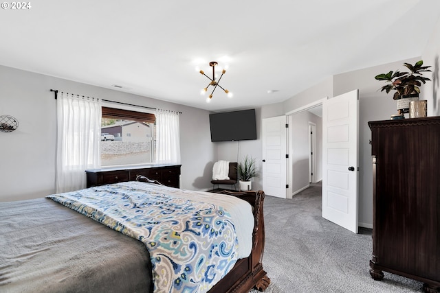 carpeted bedroom featuring a notable chandelier