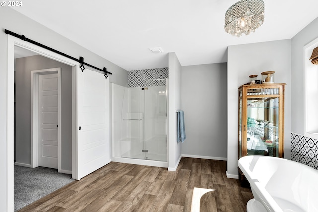 bathroom featuring hardwood / wood-style flooring and separate shower and tub