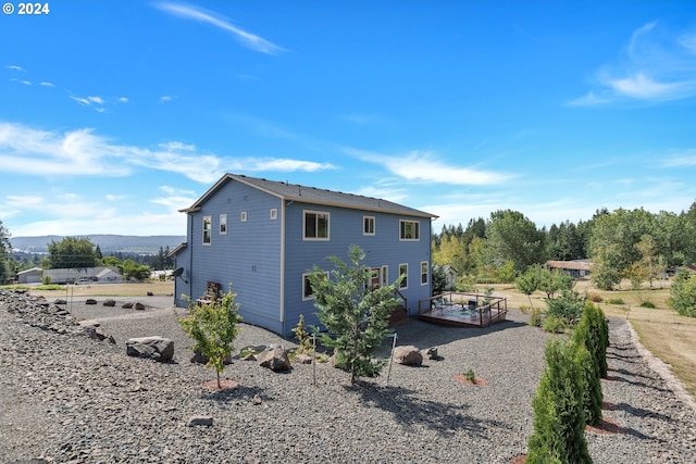 back of house with a deck with mountain view