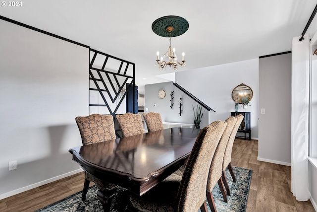 dining space with hardwood / wood-style floors and a chandelier