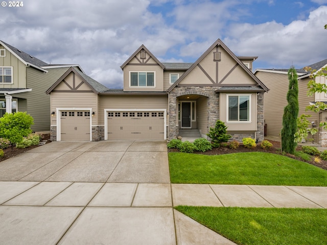 view of front of property with a front yard and a garage