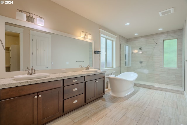 bathroom with vanity and separate shower and tub