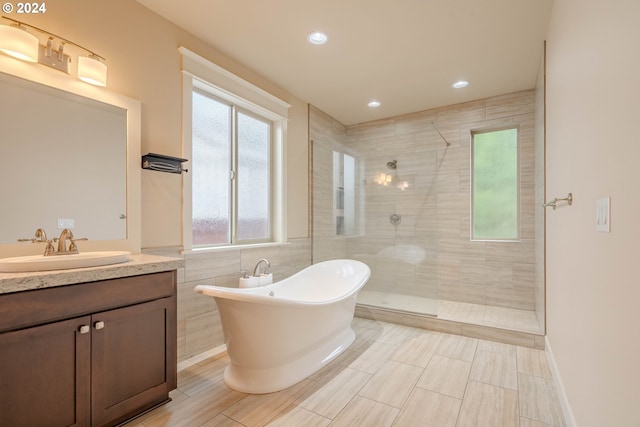 bathroom featuring plus walk in shower and vanity