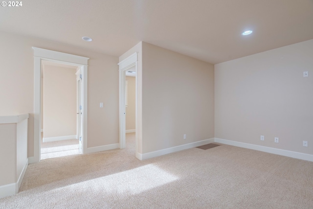 empty room featuring light colored carpet