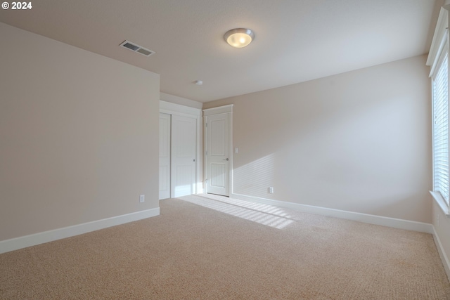 carpeted spare room with plenty of natural light