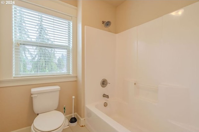 bathroom with tile patterned flooring, shower / bathing tub combination, toilet, and a healthy amount of sunlight