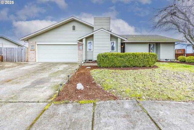 ranch-style home featuring a garage and a front lawn