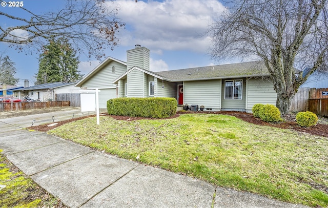 ranch-style house featuring a garage and a front lawn