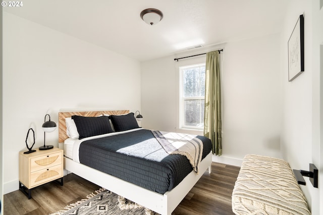 bedroom with dark hardwood / wood-style floors