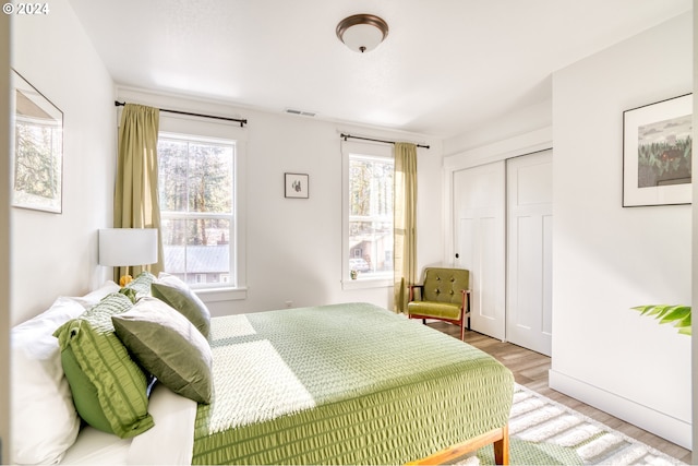 bedroom featuring a closet and light hardwood / wood-style flooring