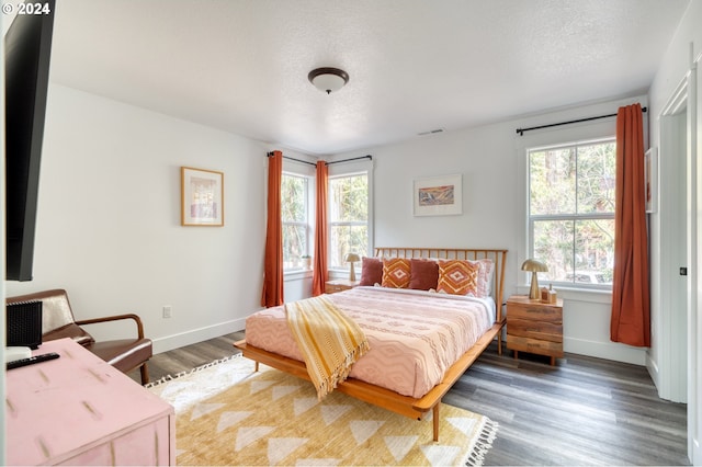 bedroom with dark hardwood / wood-style flooring