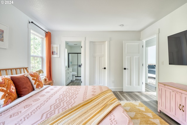 bedroom featuring hardwood / wood-style floors and ensuite bath