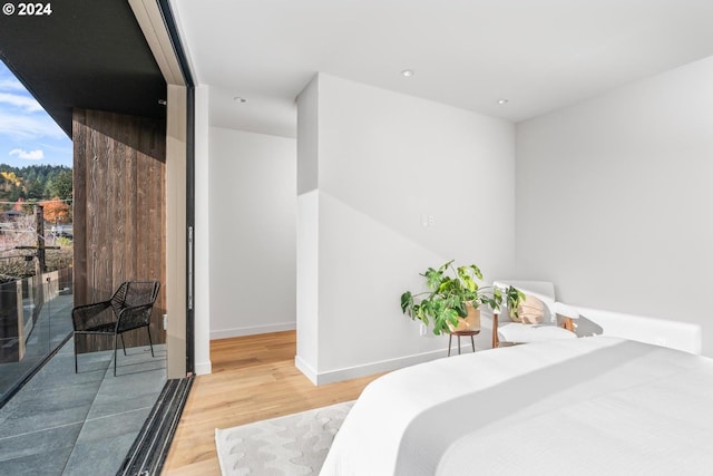 bedroom featuring hardwood / wood-style flooring and access to outside