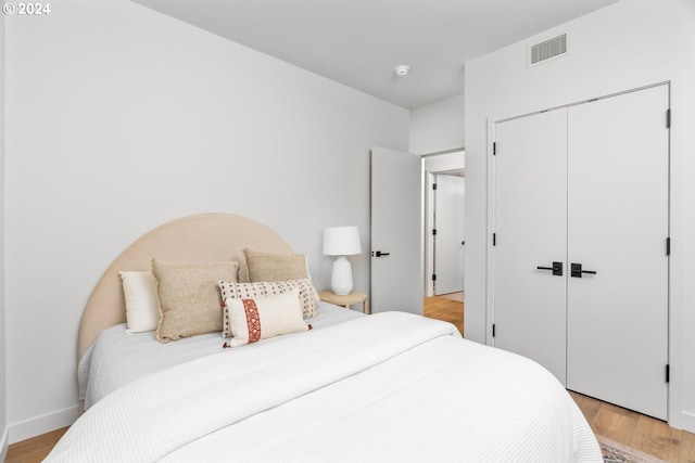 bedroom featuring a closet and light hardwood / wood-style flooring