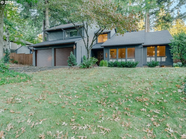 view of front facade with a garage and a front lawn