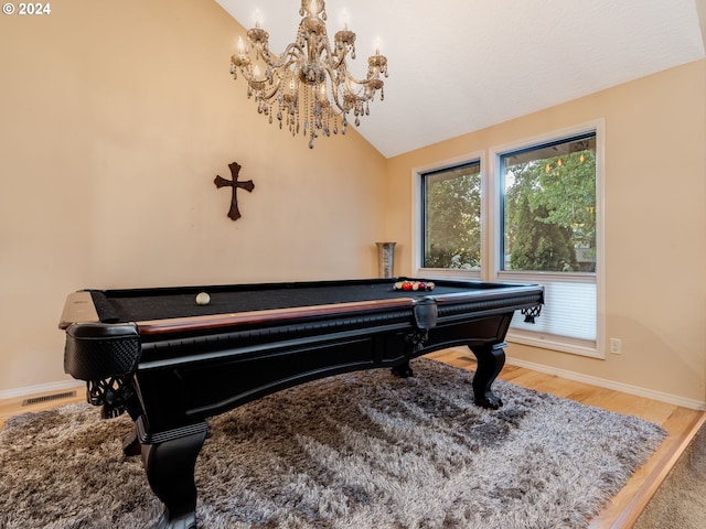 rec room with billiards, wood-type flooring, lofted ceiling, and a chandelier