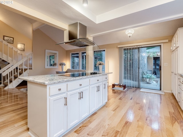 kitchen featuring extractor fan, black electric cooktop, white cabinetry, and a center island with sink