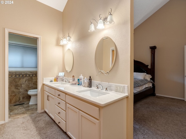 bathroom featuring vanity, vaulted ceiling, toilet, and tile patterned flooring