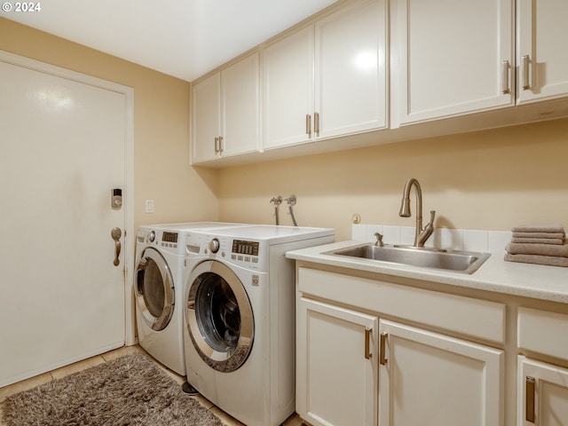 laundry area featuring cabinets, sink, separate washer and dryer, and light tile patterned floors