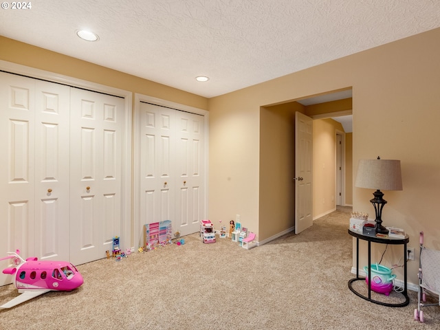 game room with carpet floors and a textured ceiling