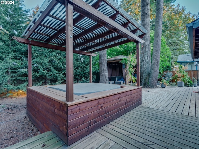 wooden deck featuring a pergola and a hot tub