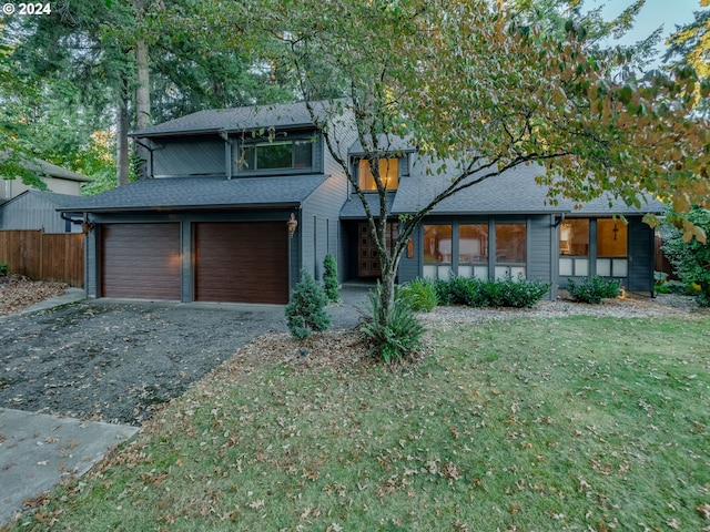 view of front of house with a front lawn and a garage