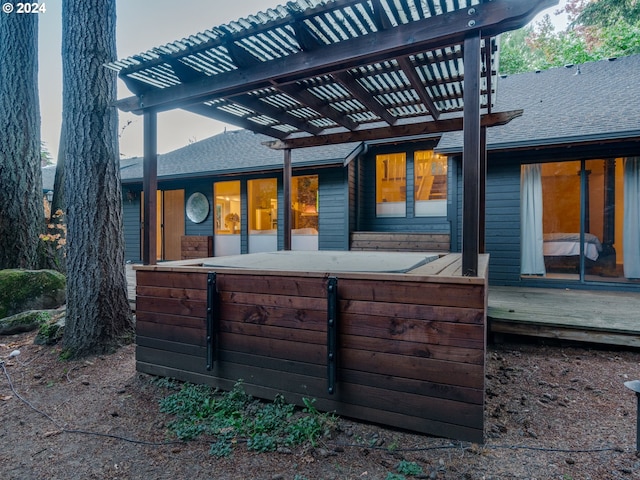 exterior space with a wooden deck and a pergola