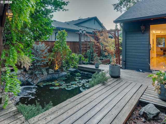 wooden deck featuring a garden pond