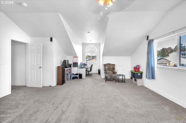 office with ceiling fan, a textured ceiling, carpet, and vaulted ceiling