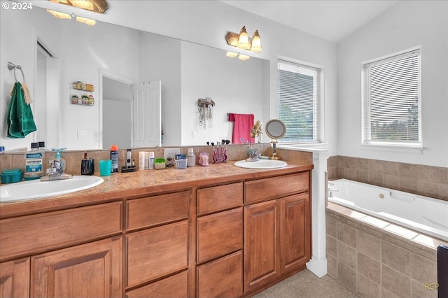 bathroom featuring vanity, lofted ceiling, tile patterned floors, and tiled bath