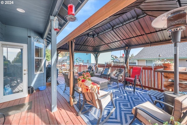 wooden deck with a gazebo and outdoor lounge area