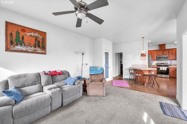 living room featuring ceiling fan and light tile patterned floors