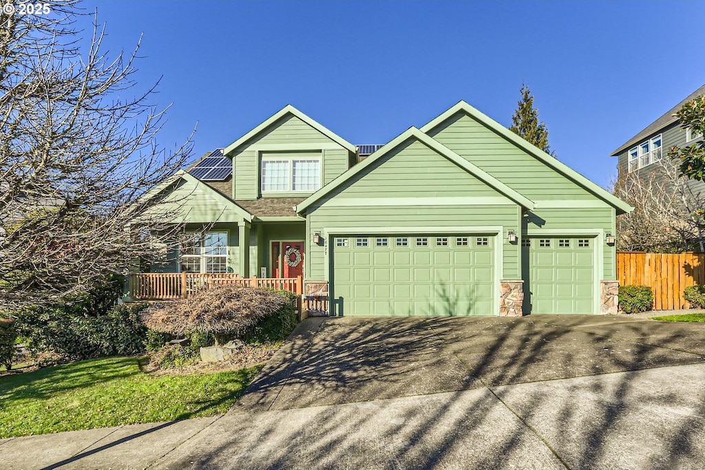 view of front of house featuring a garage and solar panels