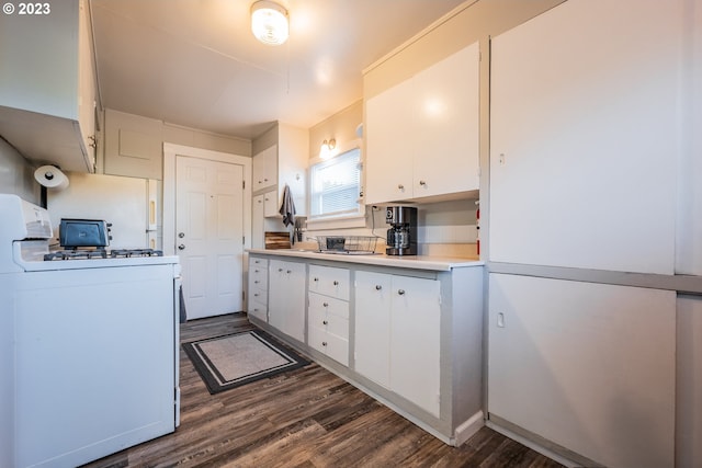 kitchen featuring white cabinets, white gas stove, and dark hardwood / wood-style flooring