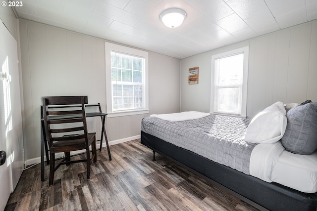 bedroom with dark hardwood / wood-style flooring