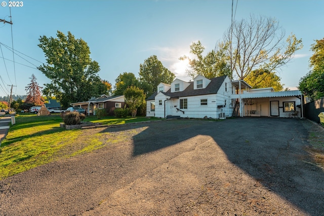 view of front facade with a front yard and a carport