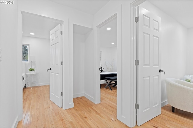 hallway with hardwood / wood-style flooring