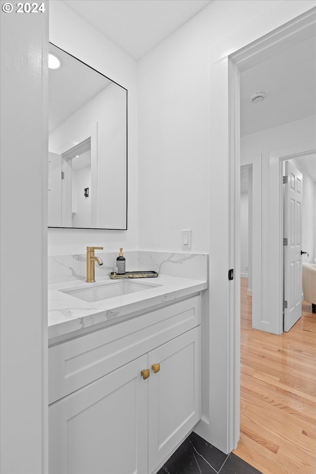 bathroom featuring vanity and hardwood / wood-style flooring