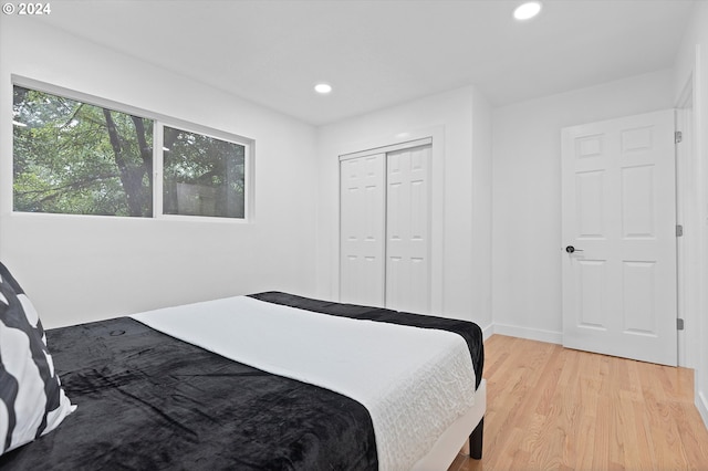 bedroom featuring light hardwood / wood-style floors and a closet