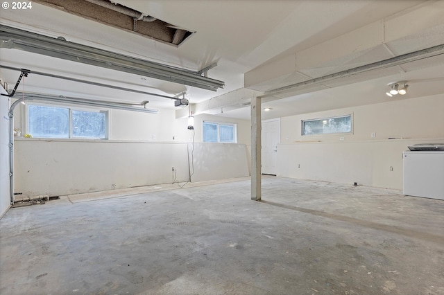 garage featuring a garage door opener and washer / clothes dryer