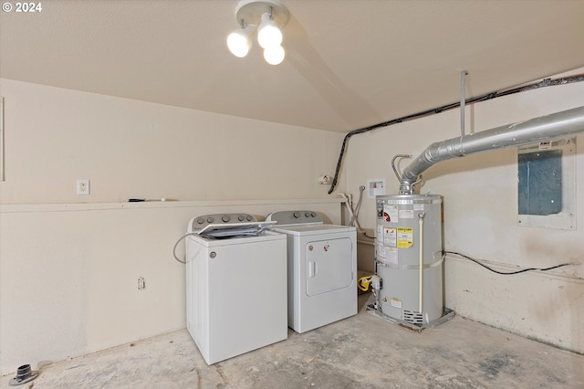 clothes washing area featuring electric panel, washer and clothes dryer, and strapped water heater