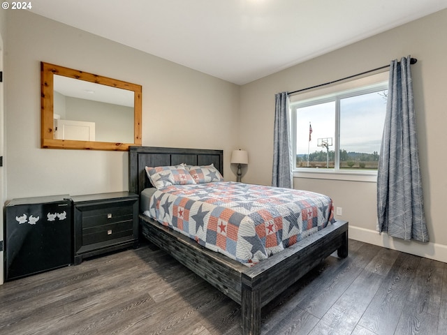 bedroom with dark hardwood / wood-style flooring