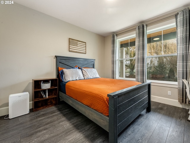 bedroom with dark hardwood / wood-style floors