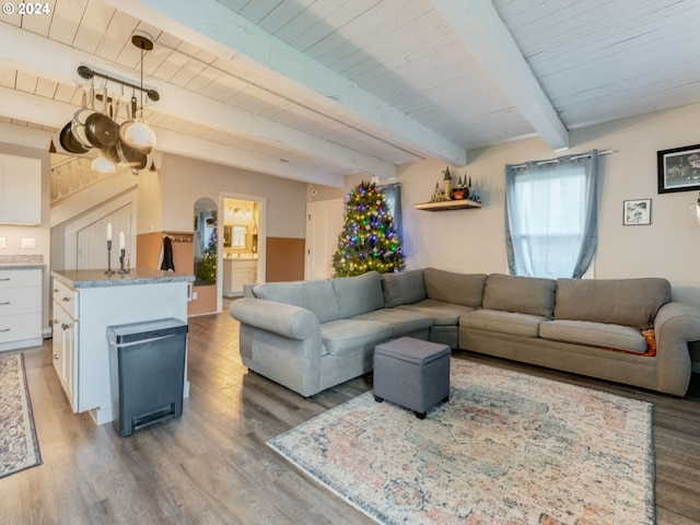 living room with beam ceiling, light wood-type flooring, and wooden ceiling