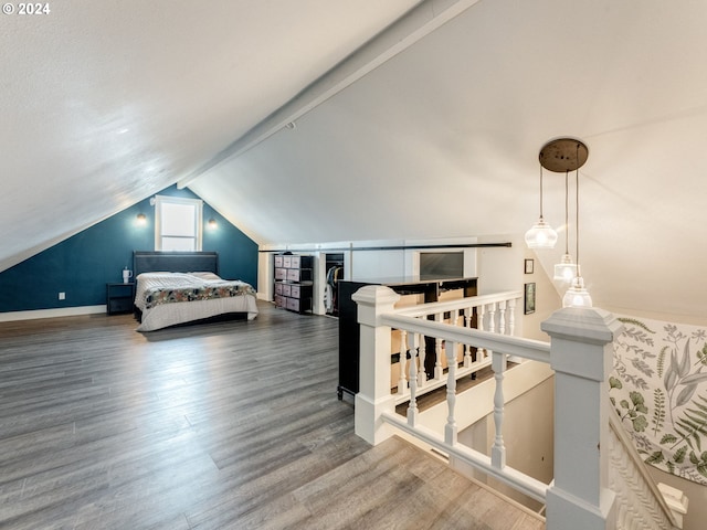 bedroom with hardwood / wood-style floors and lofted ceiling