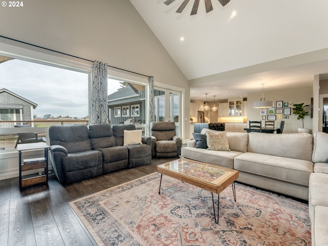 living room with dark hardwood / wood-style flooring, high vaulted ceiling, and ceiling fan