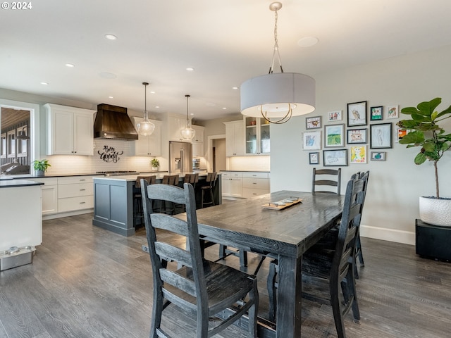 dining space featuring sink and dark wood-type flooring