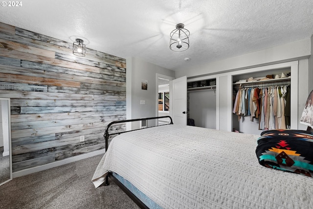 carpeted bedroom featuring wood walls and a textured ceiling