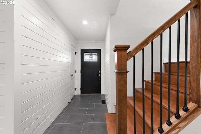 doorway to outside featuring dark tile patterned floors